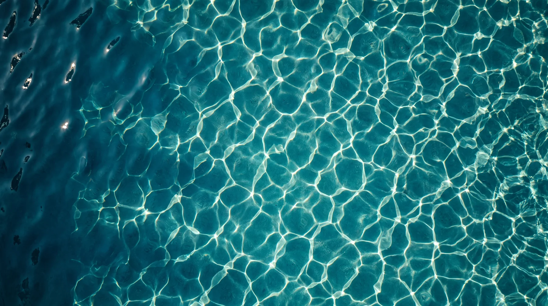 Light refracting through rippling pool water